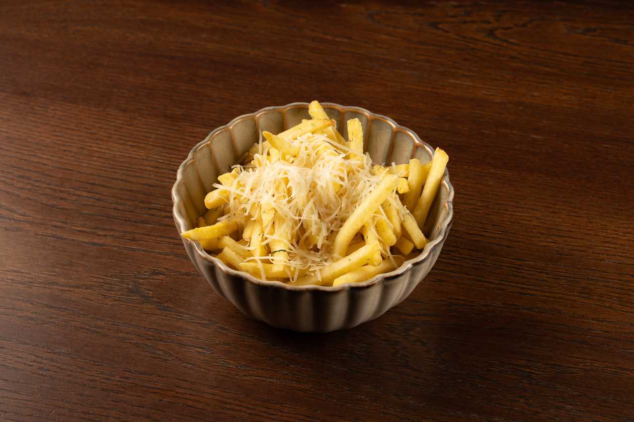 French fries with truffle oil, hard cheese and sauce