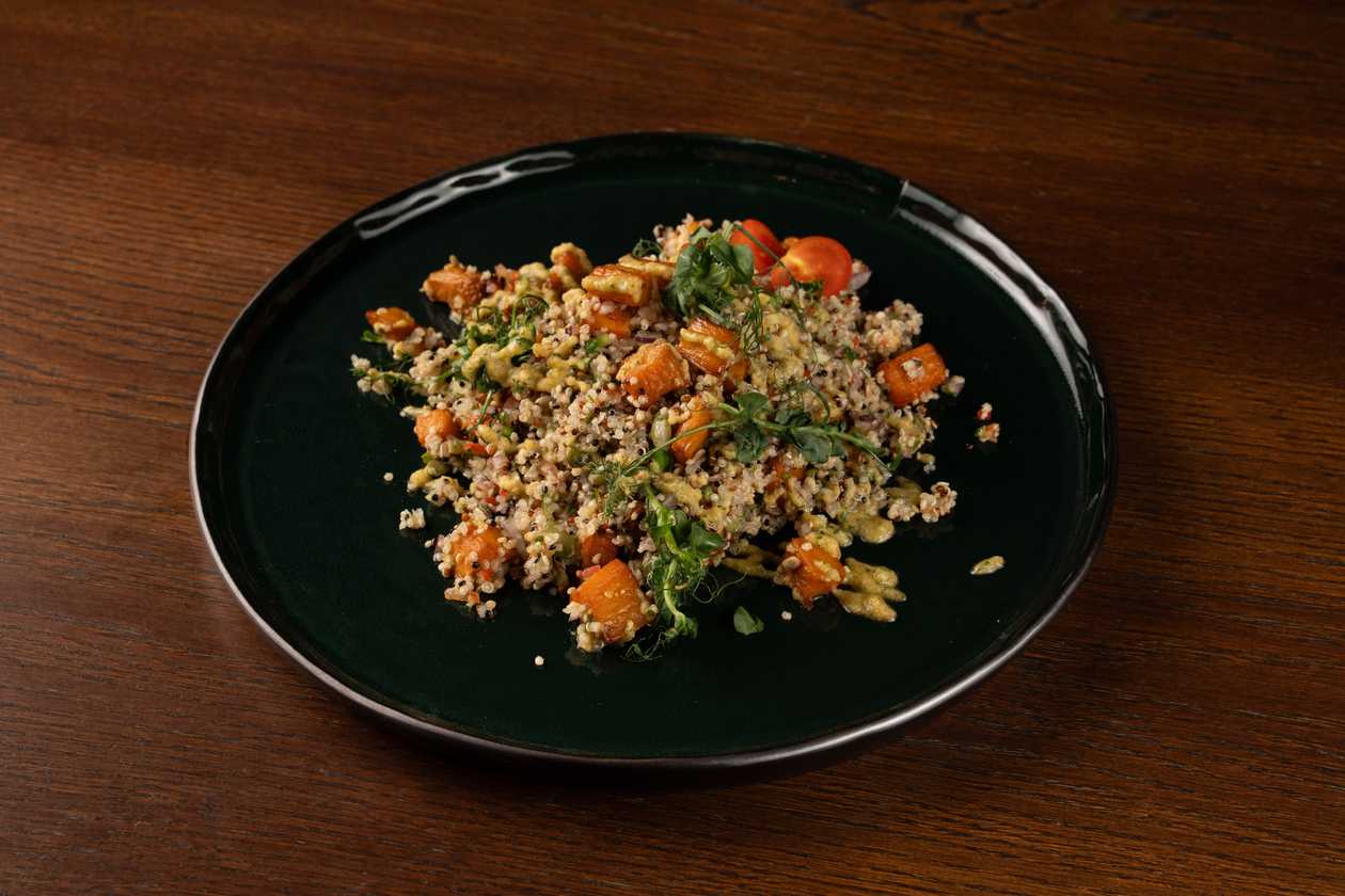 Quinoa salad with sweet potato, hummus dressing and seeds
