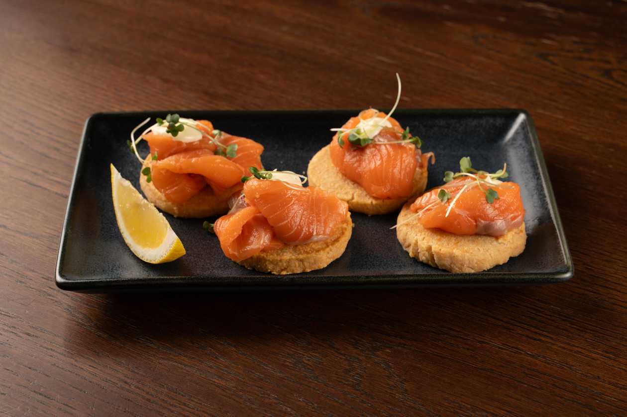 Tapas with salmon, parmesan crackers and citrus aioli