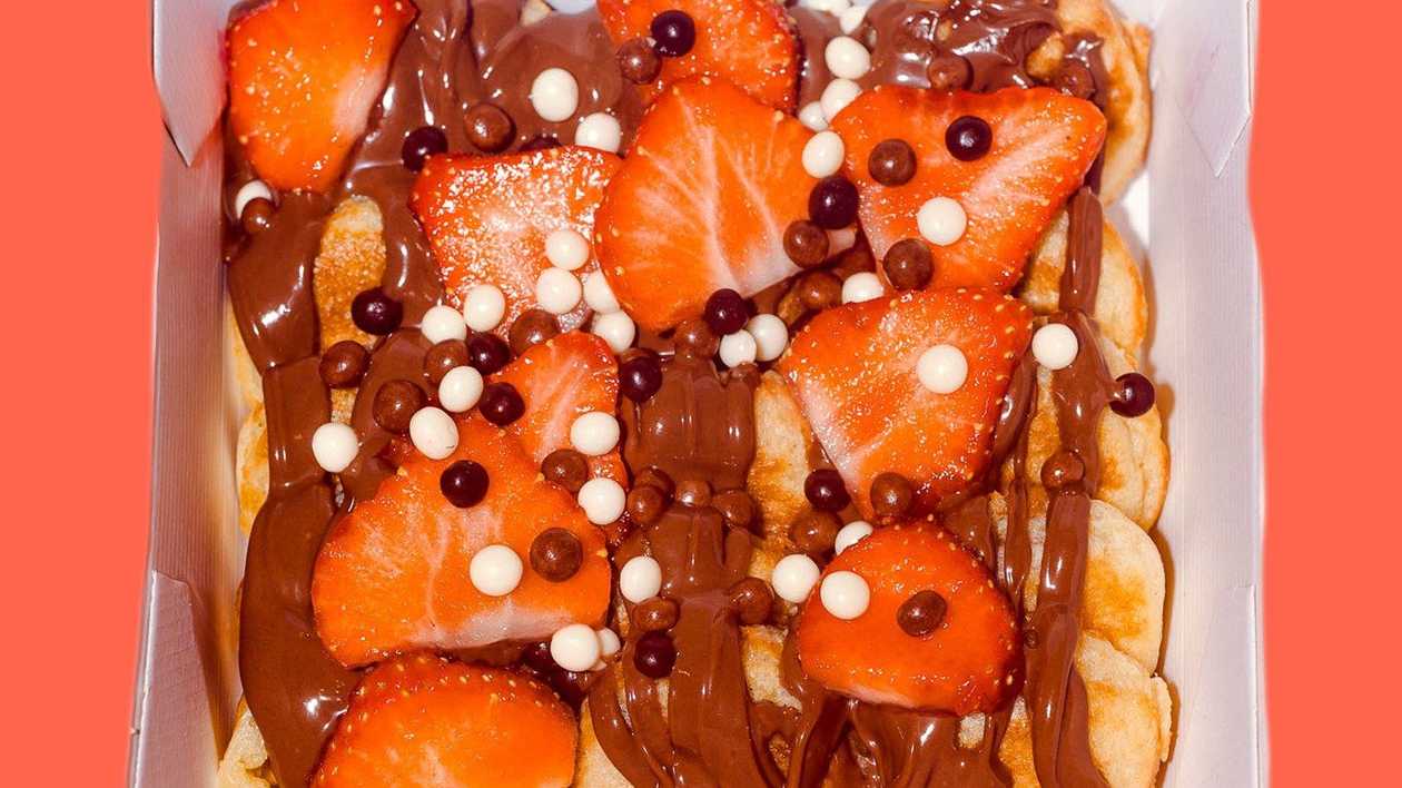 Chocolate covered pancakes with strawberries