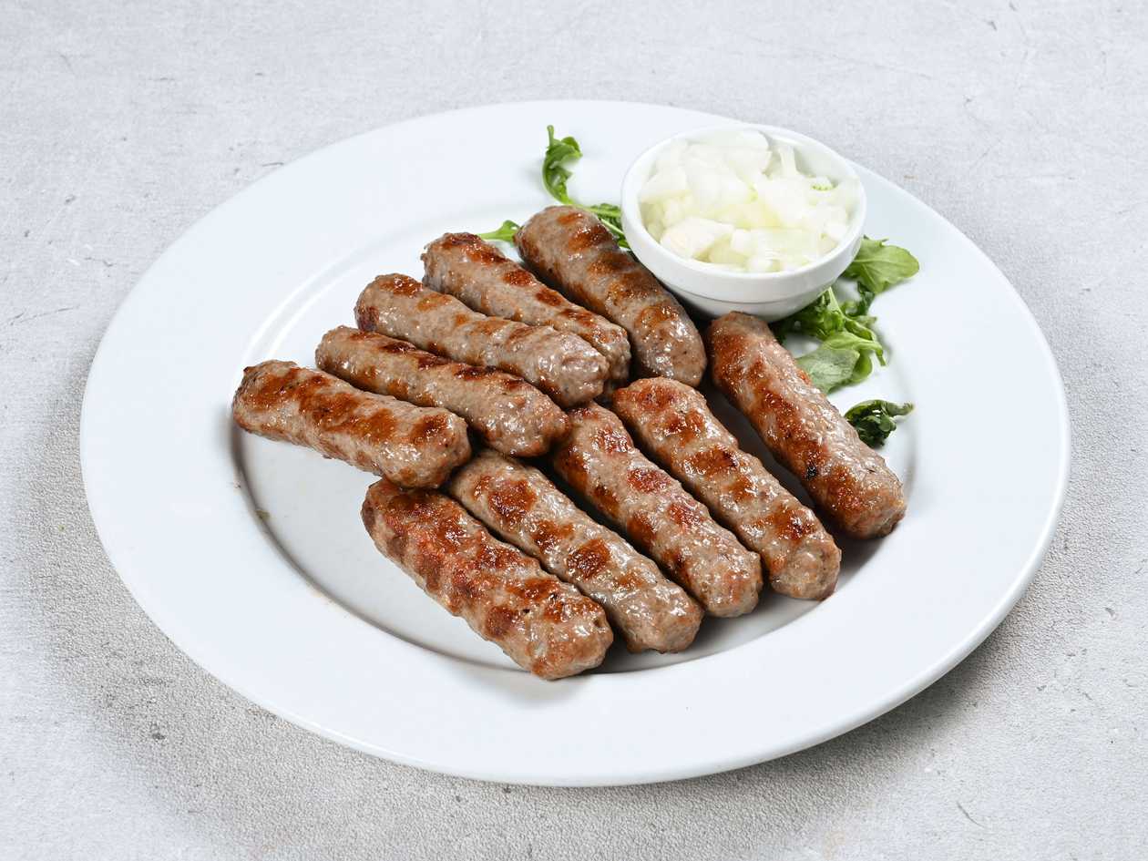 Cevaps in kajmak cream and a flatbread