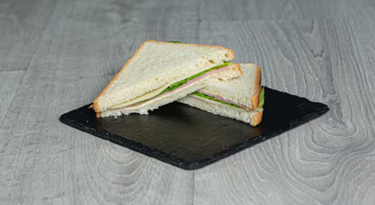 Sliced bread with ham, cheese and lettuce