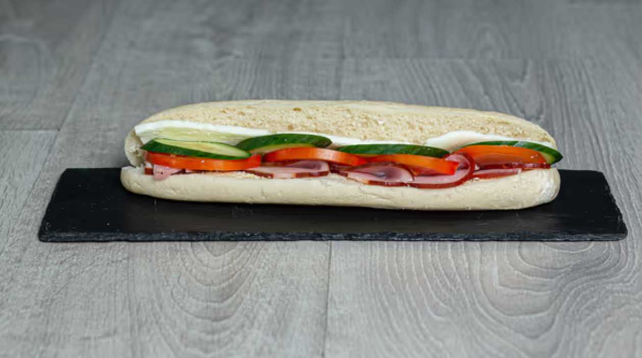 Round bagel with lountza, halloumi, tomato