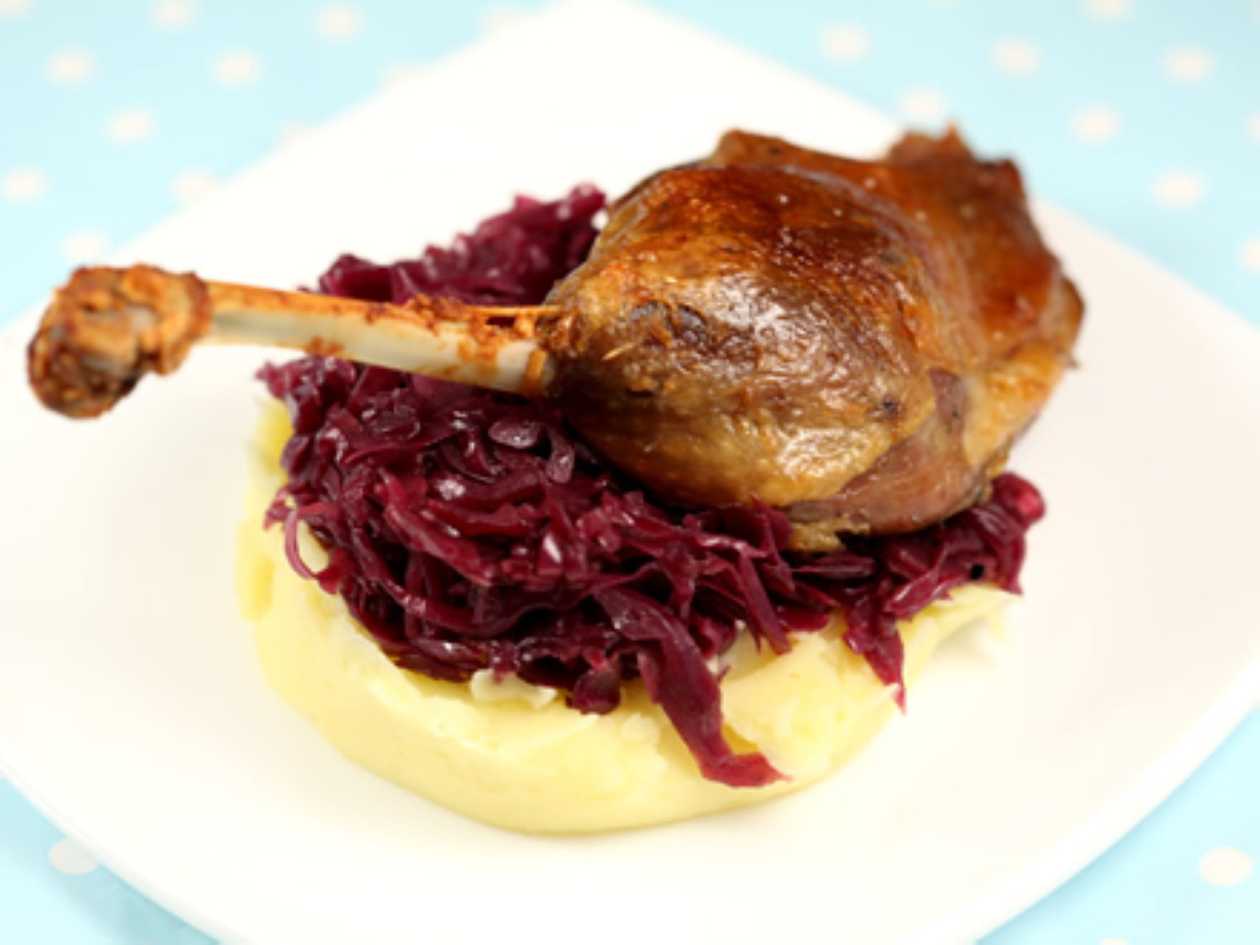 Duck breast on a bed of glazed red cabbage and baby carrots