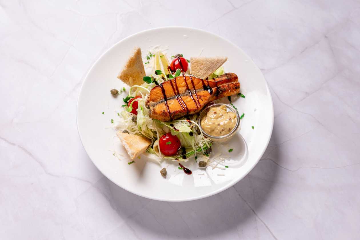 Caesar salad with salmon fillet steak