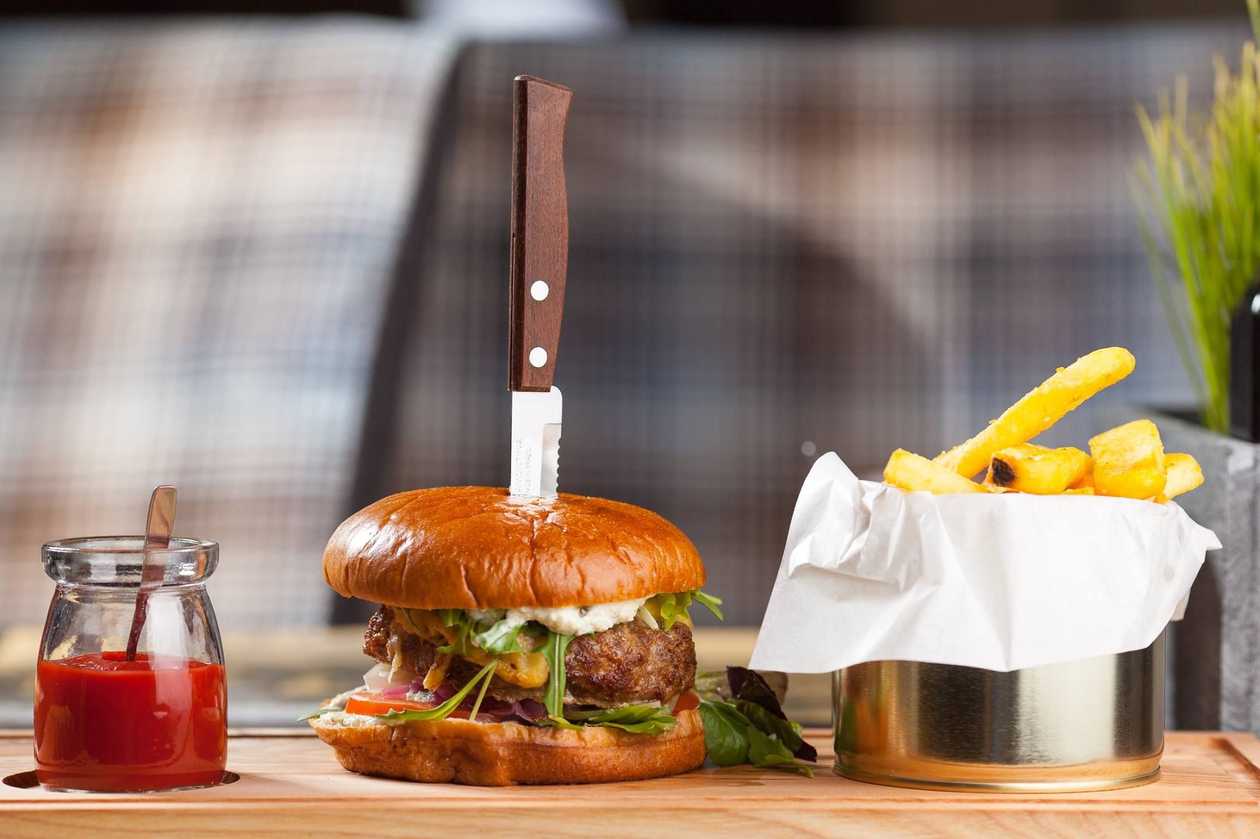 Latvian beef burger with french fries and ketchup
