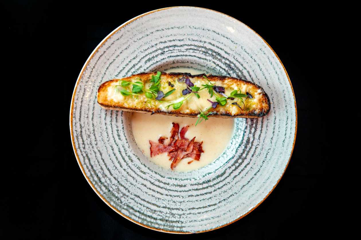 Garlic cream soup with crunchy bacon and more