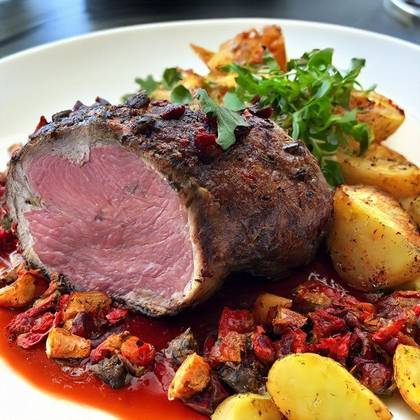 Stuffed pork tenderloin with dried tomatoes and pancetta, roasted potatoes, bacon, onions, pepper sauce