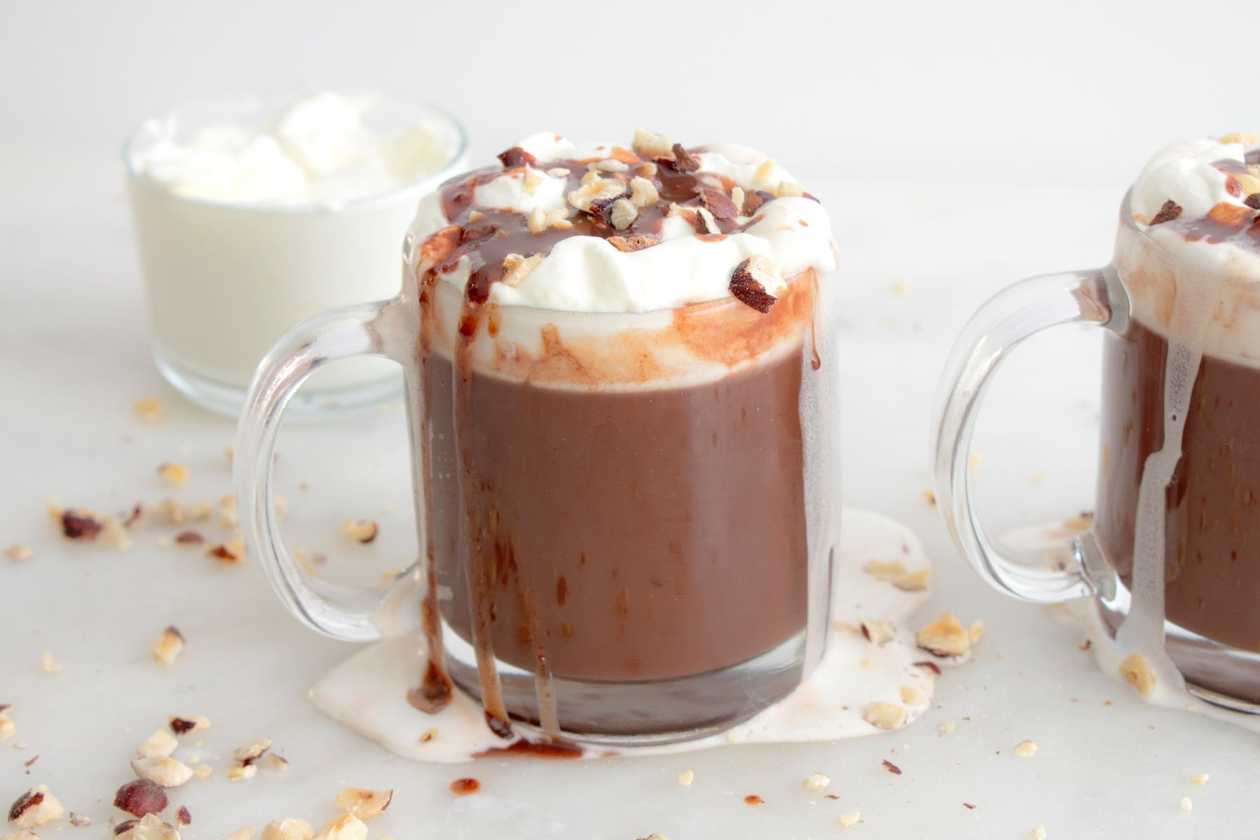 Invincible hot chocolate with whipped cream and topping