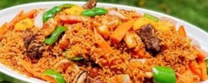 Jollof with sausage fried plantain and salad