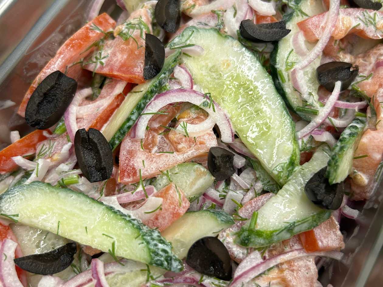 Cucumber and tomato salad with sour cream