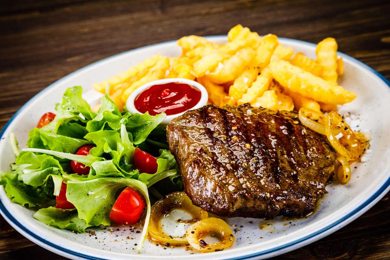 Grilled beef steak, roasted potatoes, pepper sauce