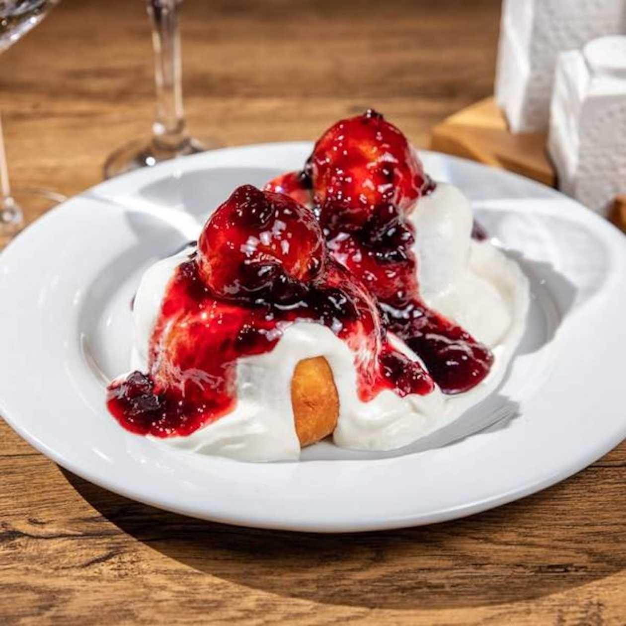 Romanian cheese doughnuts with sour cream and sour cherry jam