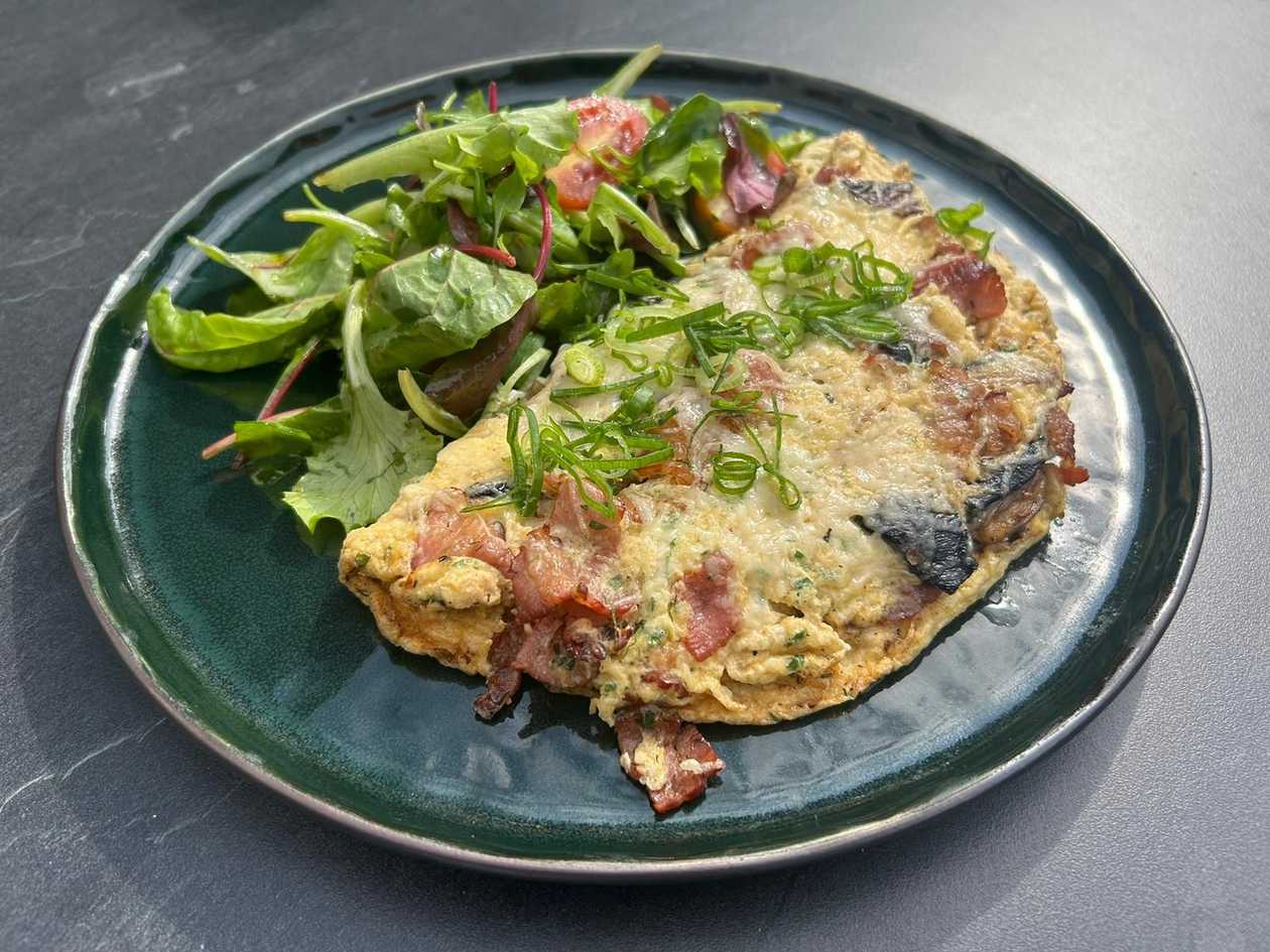 Omelette with mushrooms, bacon and hard cheese