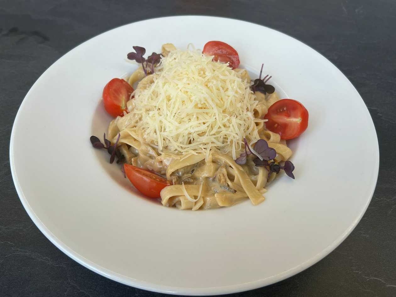 Pasta tagliatelle with boletus and hard cheese