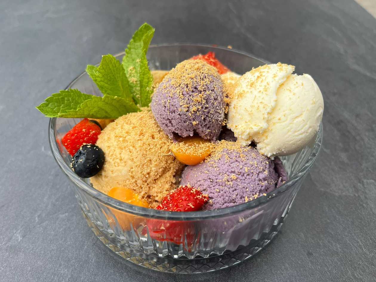 Selection of ice cream with chocolate or caramel sauce and fresh berries
