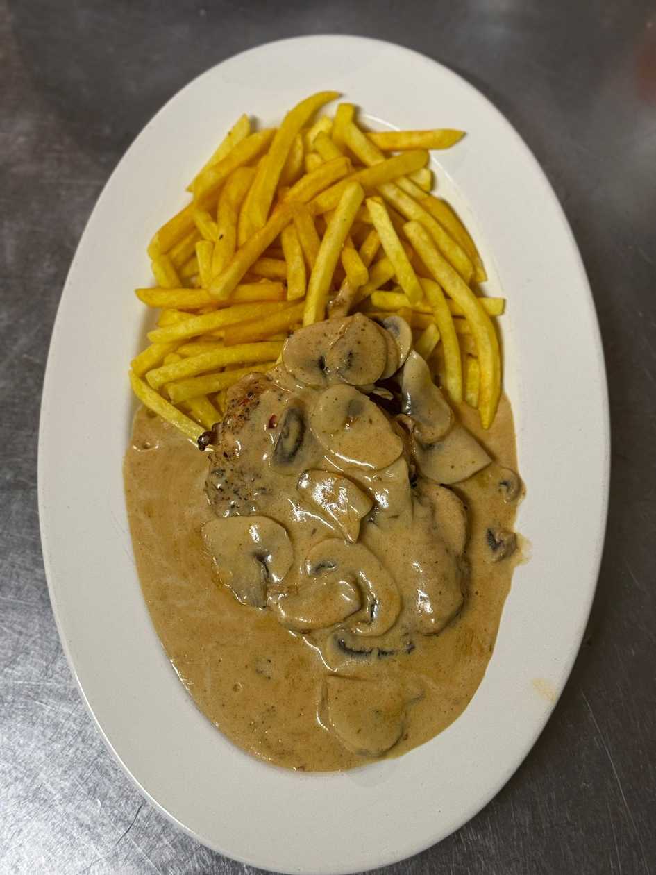 Pork steak from collar on mushrooms