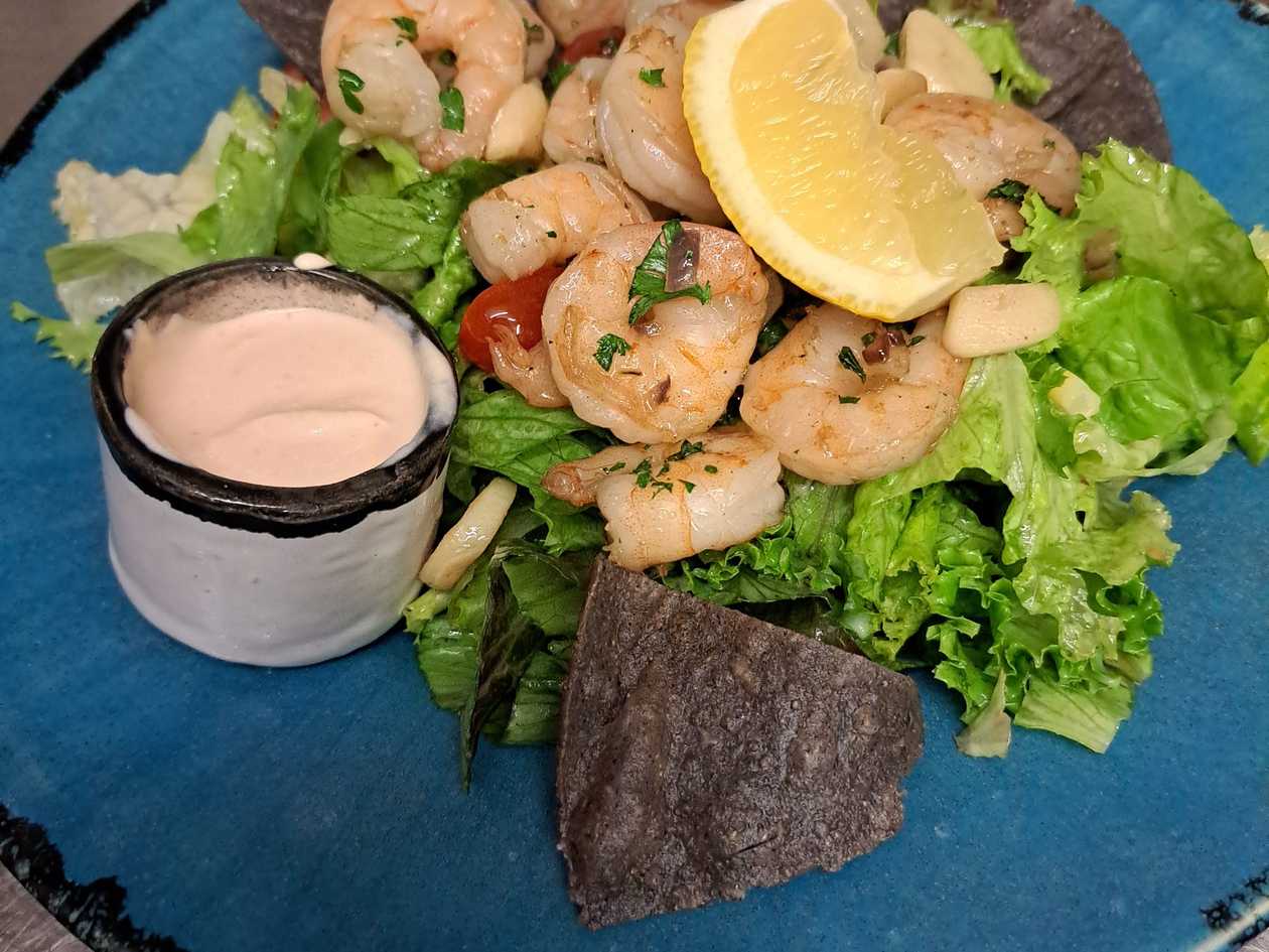 Grilled shrimp on lettuce leaves