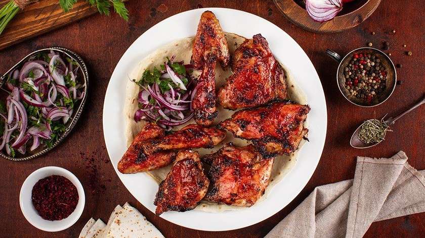Chick with cherry plum sauce on grill