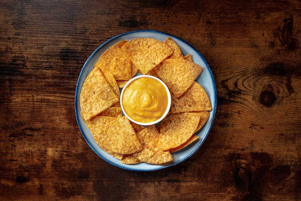 Nachos with cheese sauce and salsa
