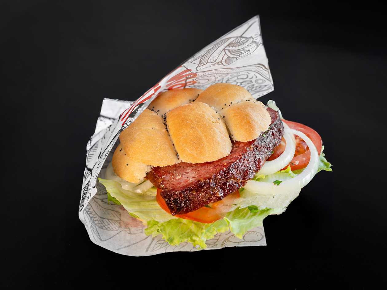 Butcher meatloaf in a bun (mustard, ketchup, iceberg lettuce, tomato, onion)