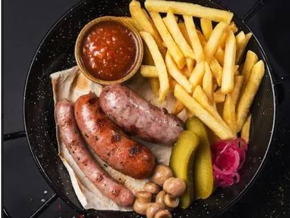 Пательня з домашніми ковбасками та хрусткою картоплею фрі
