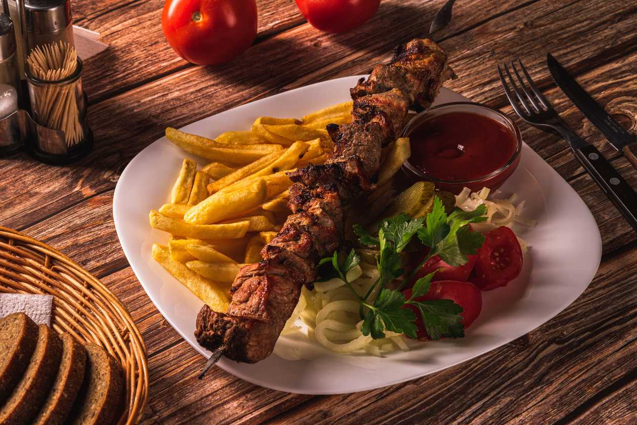 Pork shashlik with French fries and ketchup