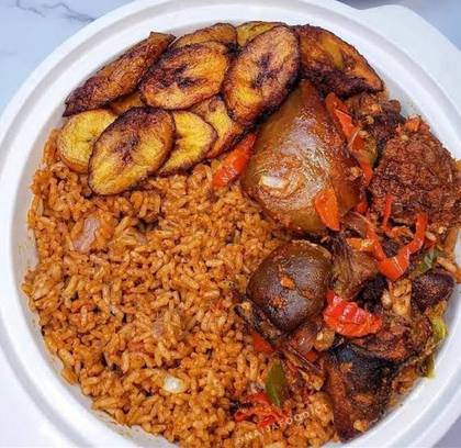 Jollof Rice served with Fried Goat Meat& Plantains