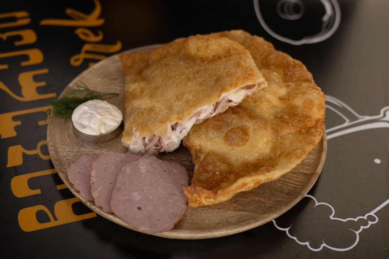 Cheburek With Ham And Cheese And Garlic Sauce