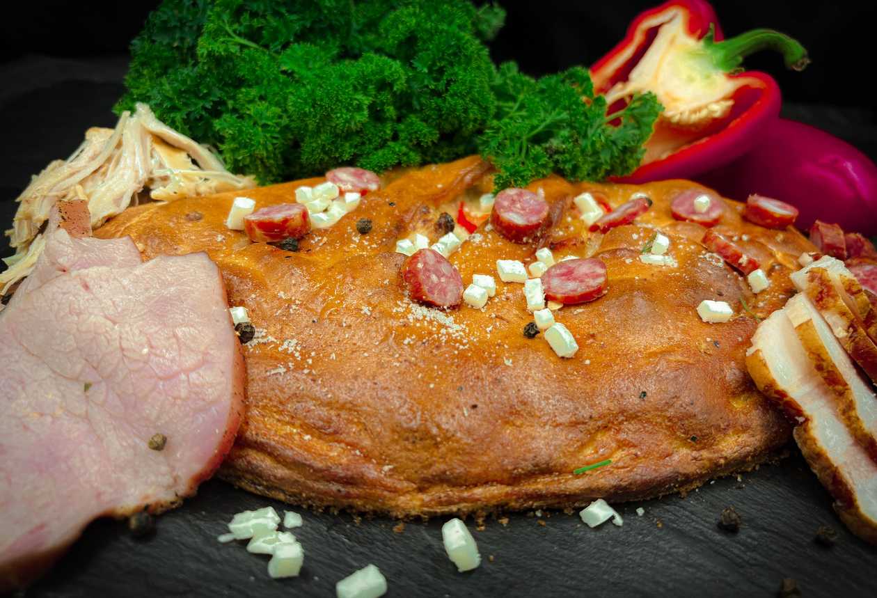 Pie with Roasted Chicken, Hunter Sausages, Ham, Olives and Tomatoes
