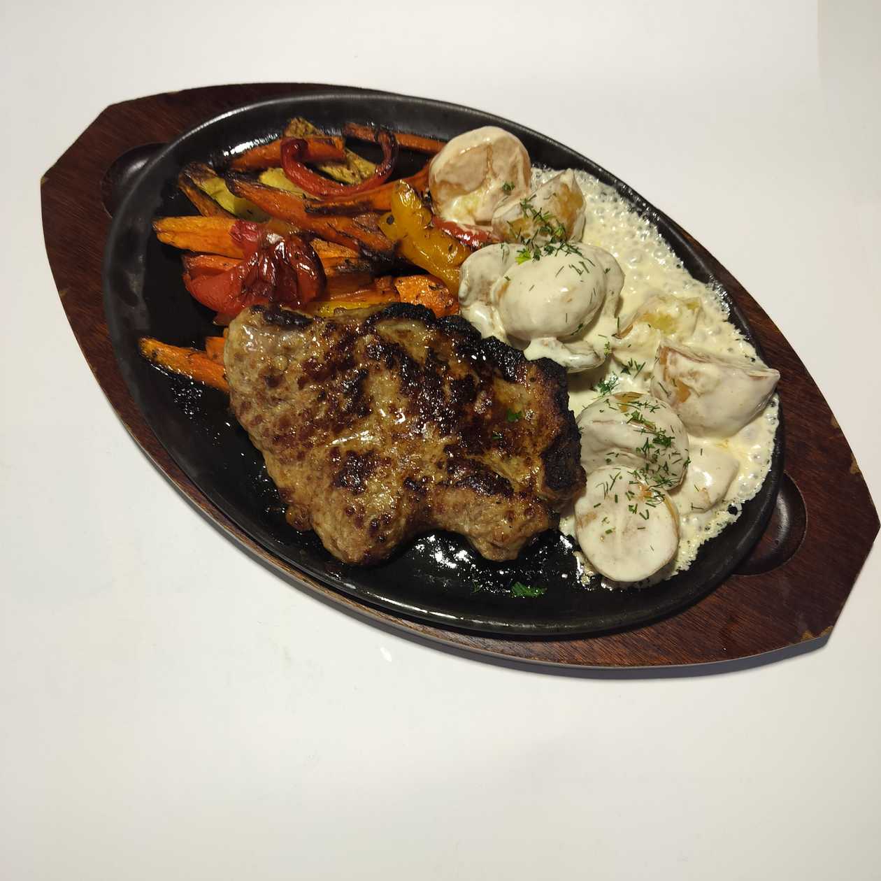 Grilled mustard pork chop with cowboy potatoes and fresh salad
