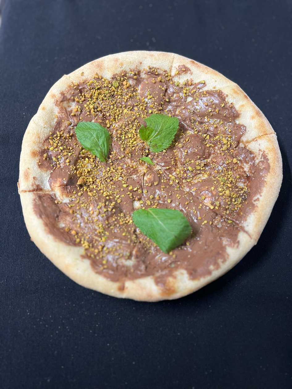 Pizza with hazelnut cream and crunchy pistachios