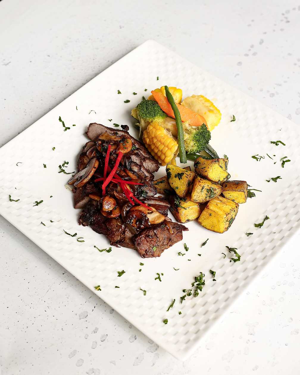 Seared Steak with Caramelized Onions, Mushrooms, Steamed Veggies & Sautéed Herb Potatoes