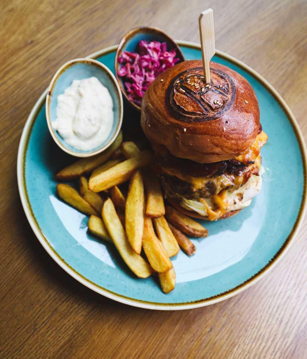 Grant burger REPUBLIKA, our aged ground beef, bacon, farm fries, coleslaw, homemade tartar sauce