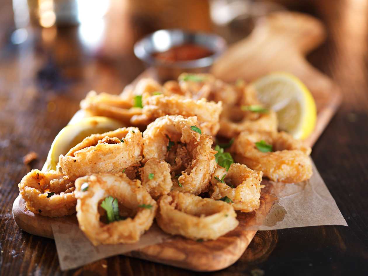 Mix of deep - fried breaded olives, calamari and onion rings