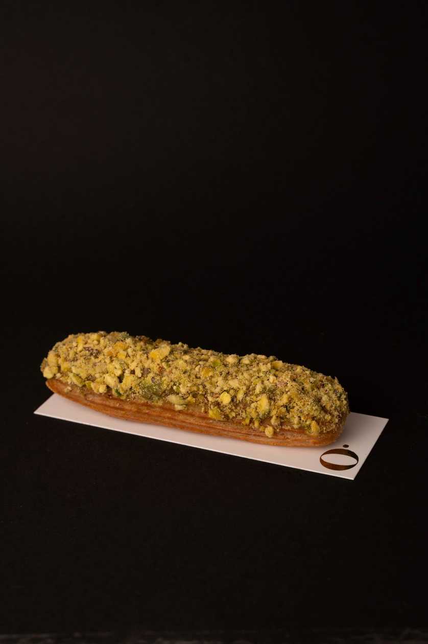 French choux pastry, pistachio gahache with white chocolate, pistachio topping