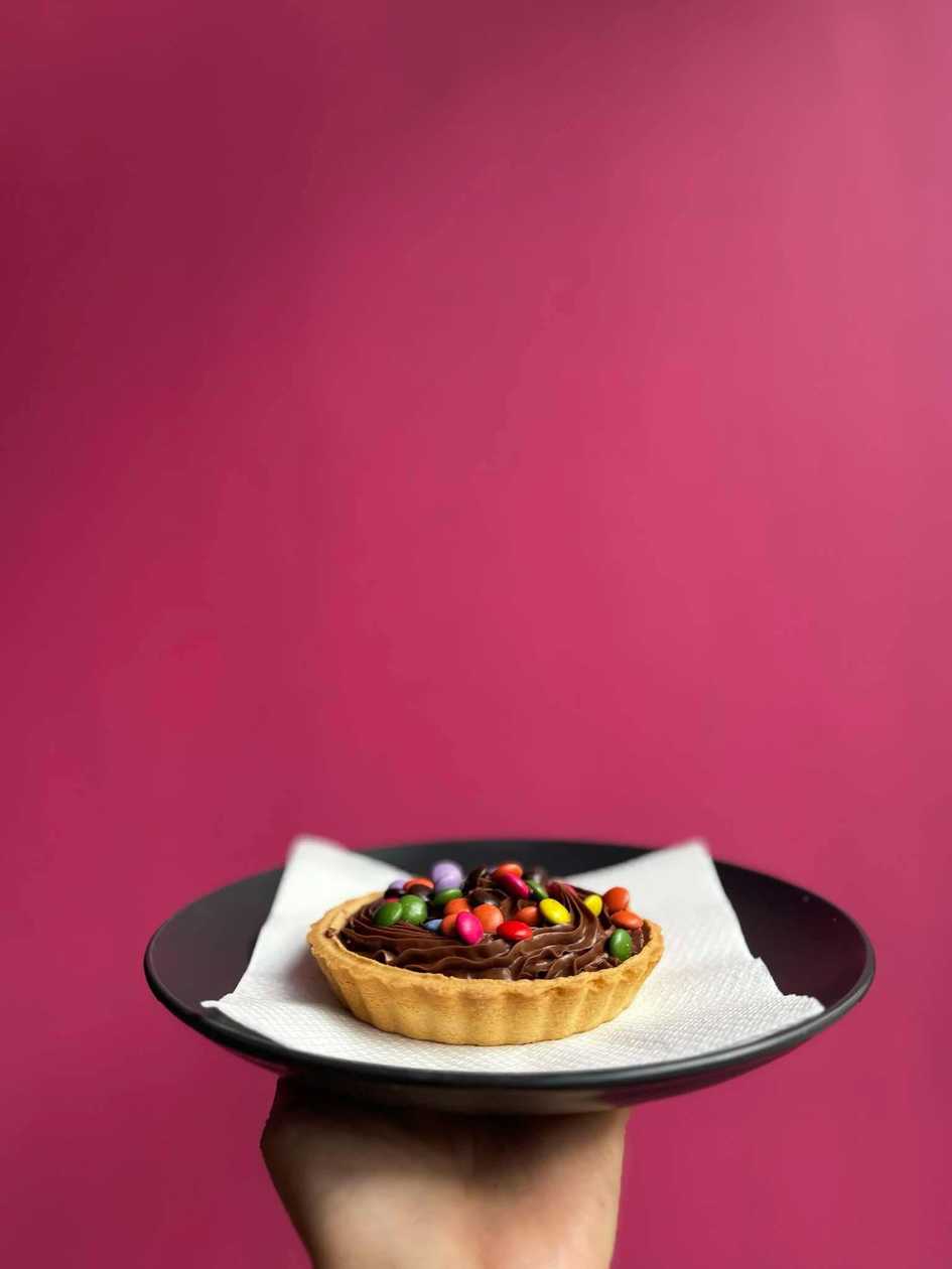 Tart filled with nutella with smarties on top