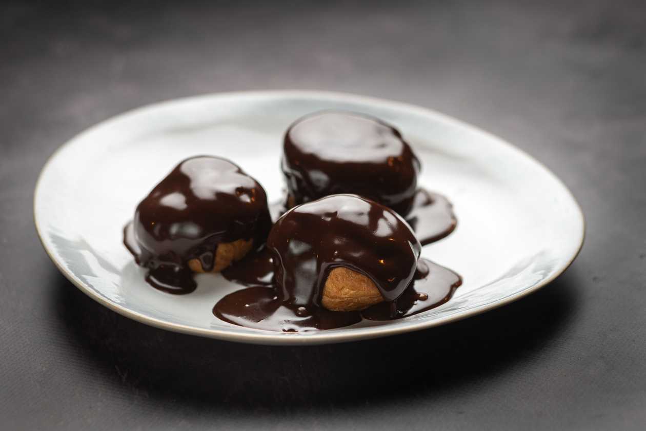 Profiteroles with whipped cream and chocolate glaze