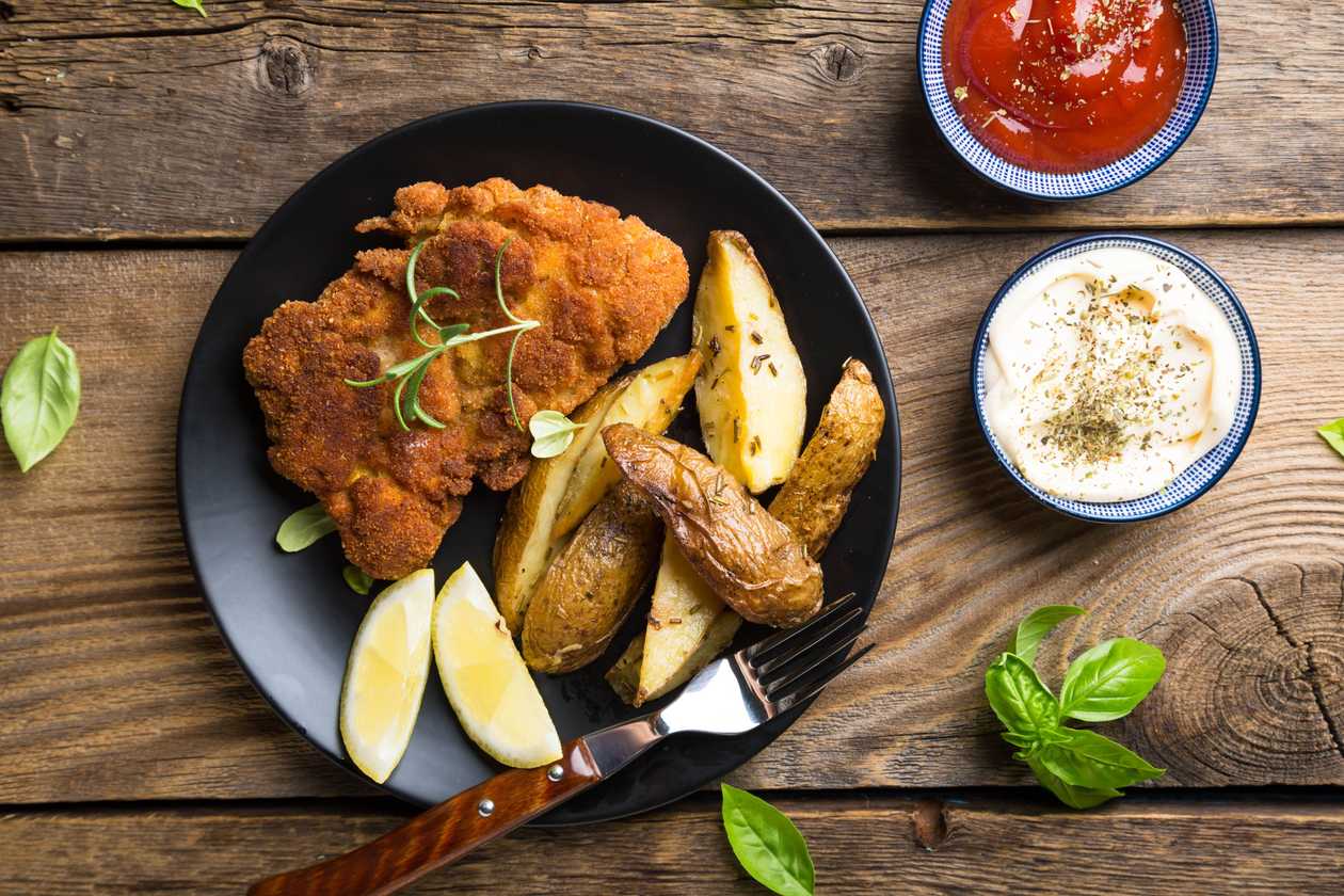 Fried chicken schnitzel with french fries/mashed potato