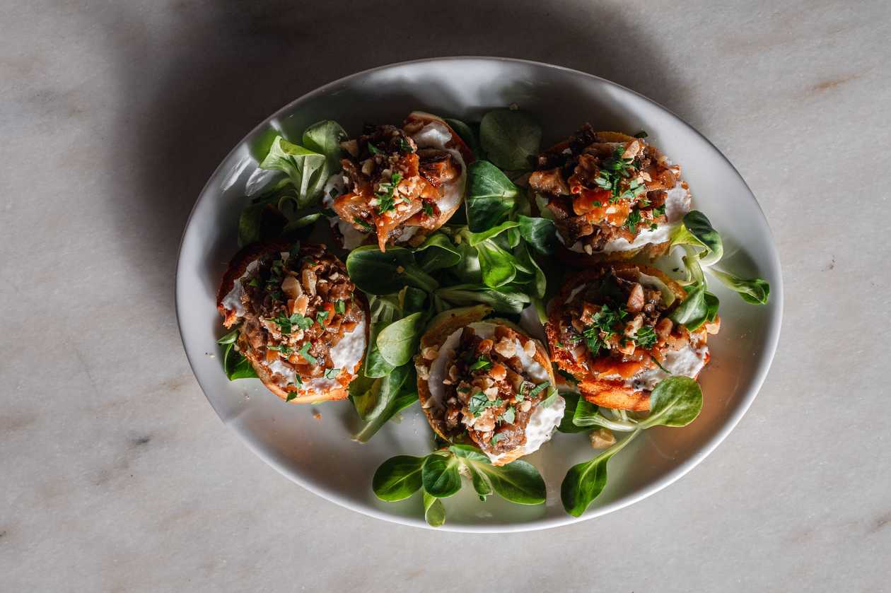 Marinated eggplant tartare, caramelized onions with mustard, ricotta cheese, walnuts and parsley