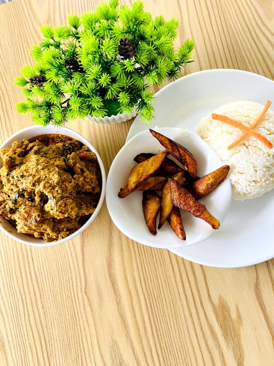 Egusi soup with rice and fried plantains