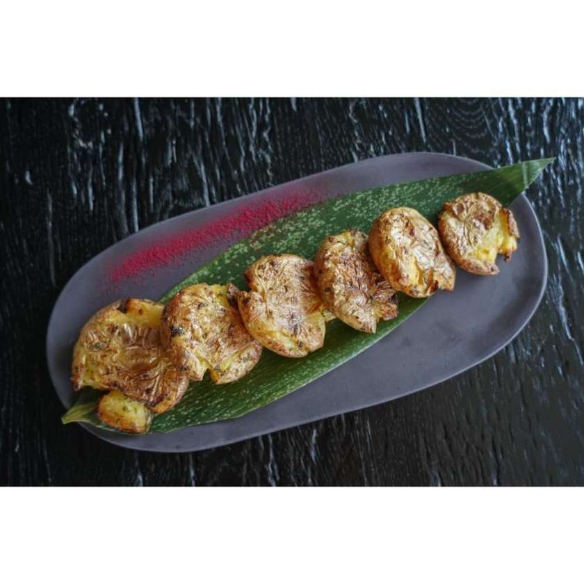 Oven-baked smashed potatoes with flavored butter