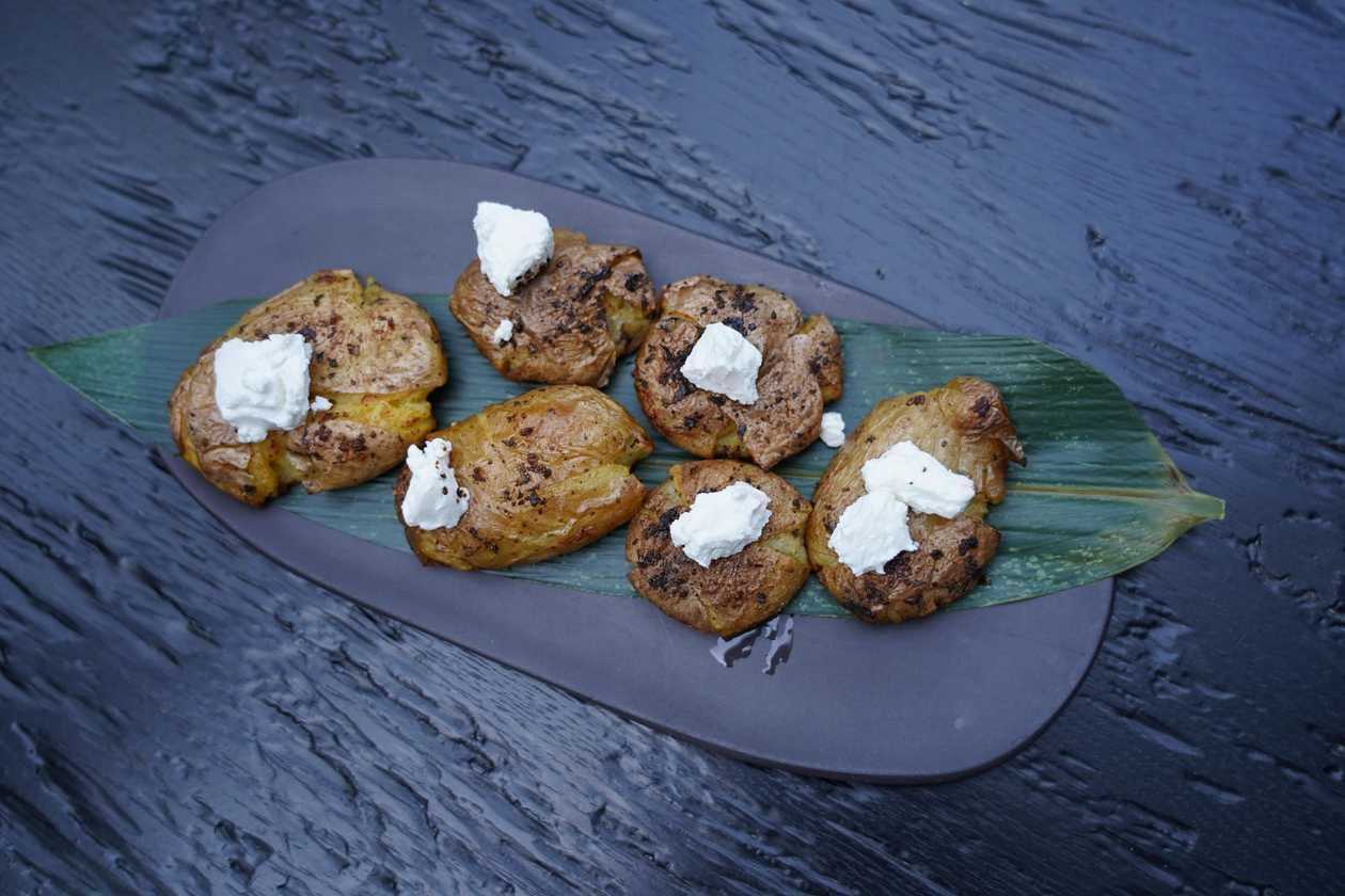 Oven-baked smashed potatoes with goat cheese