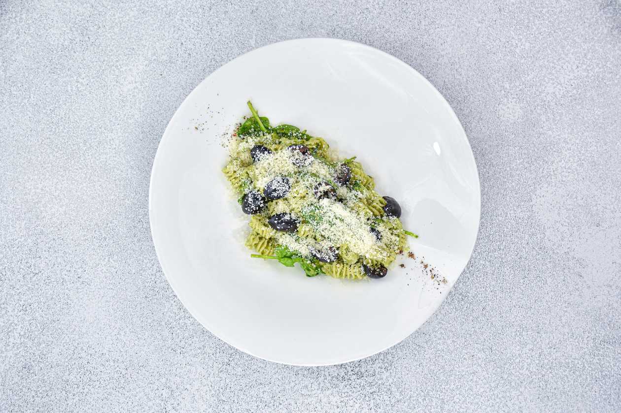 With fresh spinach, olives and basil pesto sauce