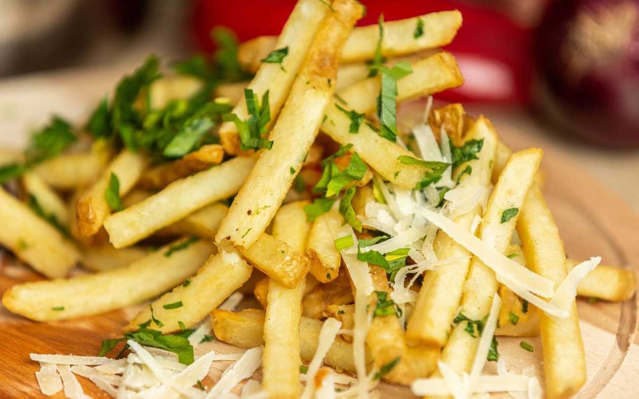 Freshly fried fries with garlic and parmesan