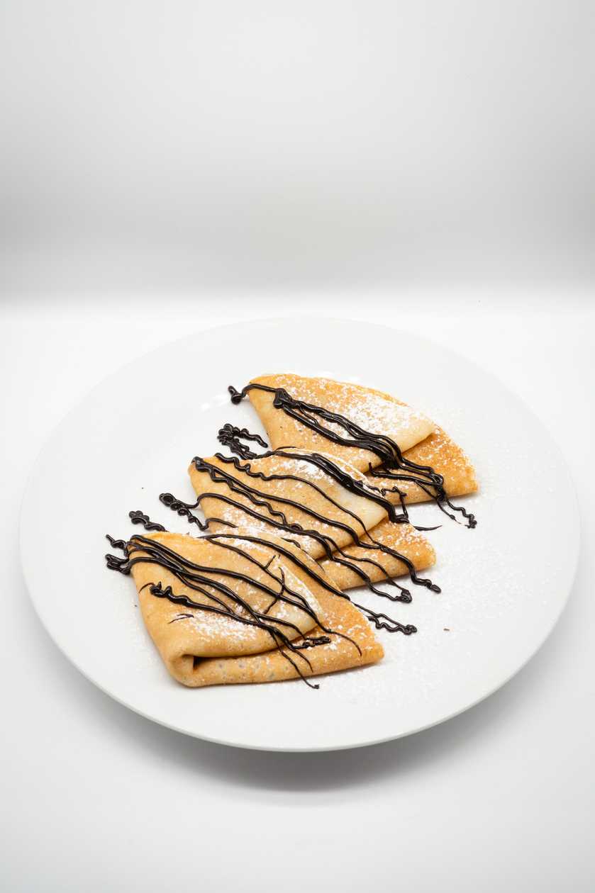 Pancakes with nougat cream, chocolate topping and whipped cream