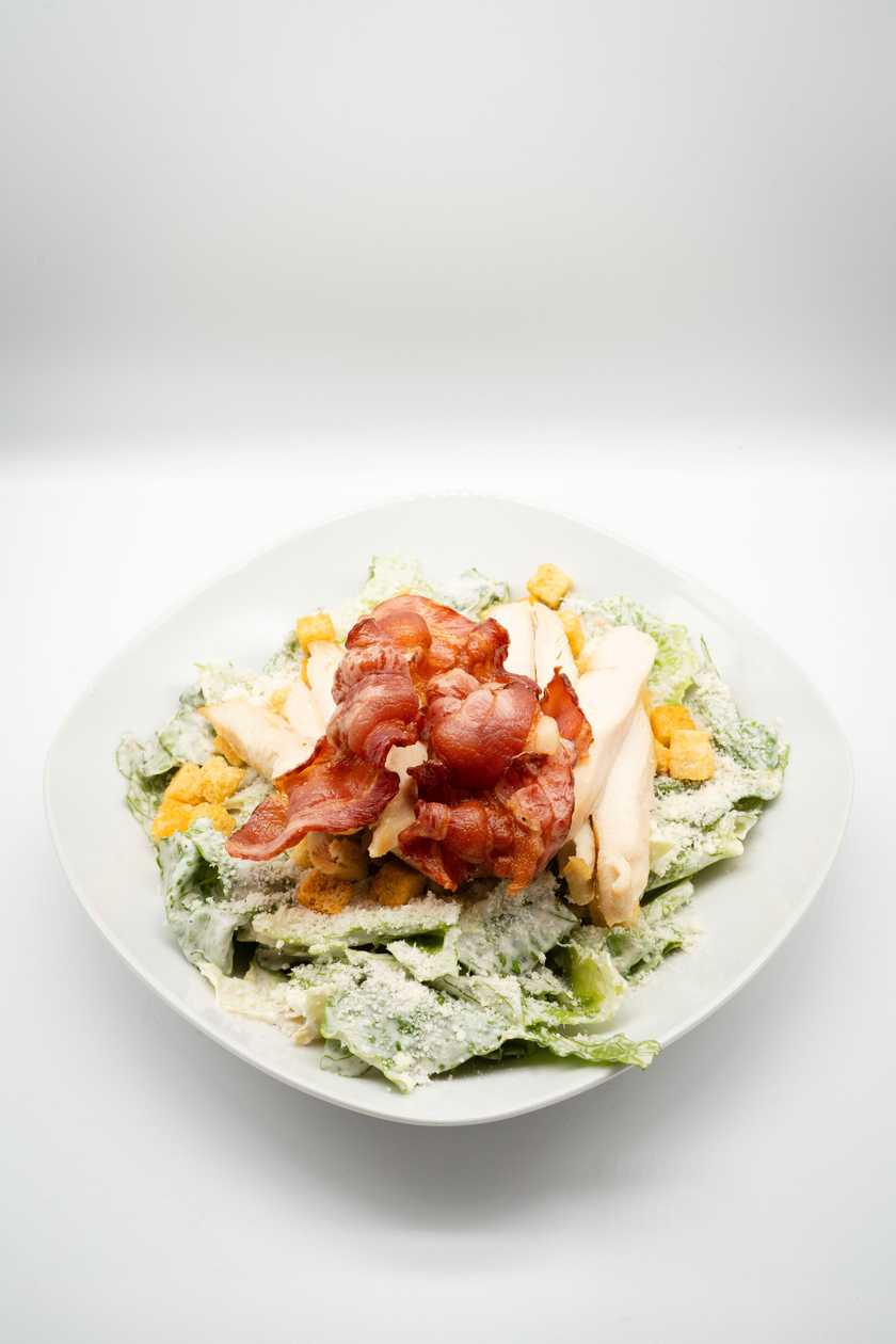Caesar salad with chicken, parmesan, croutons and bacon chips