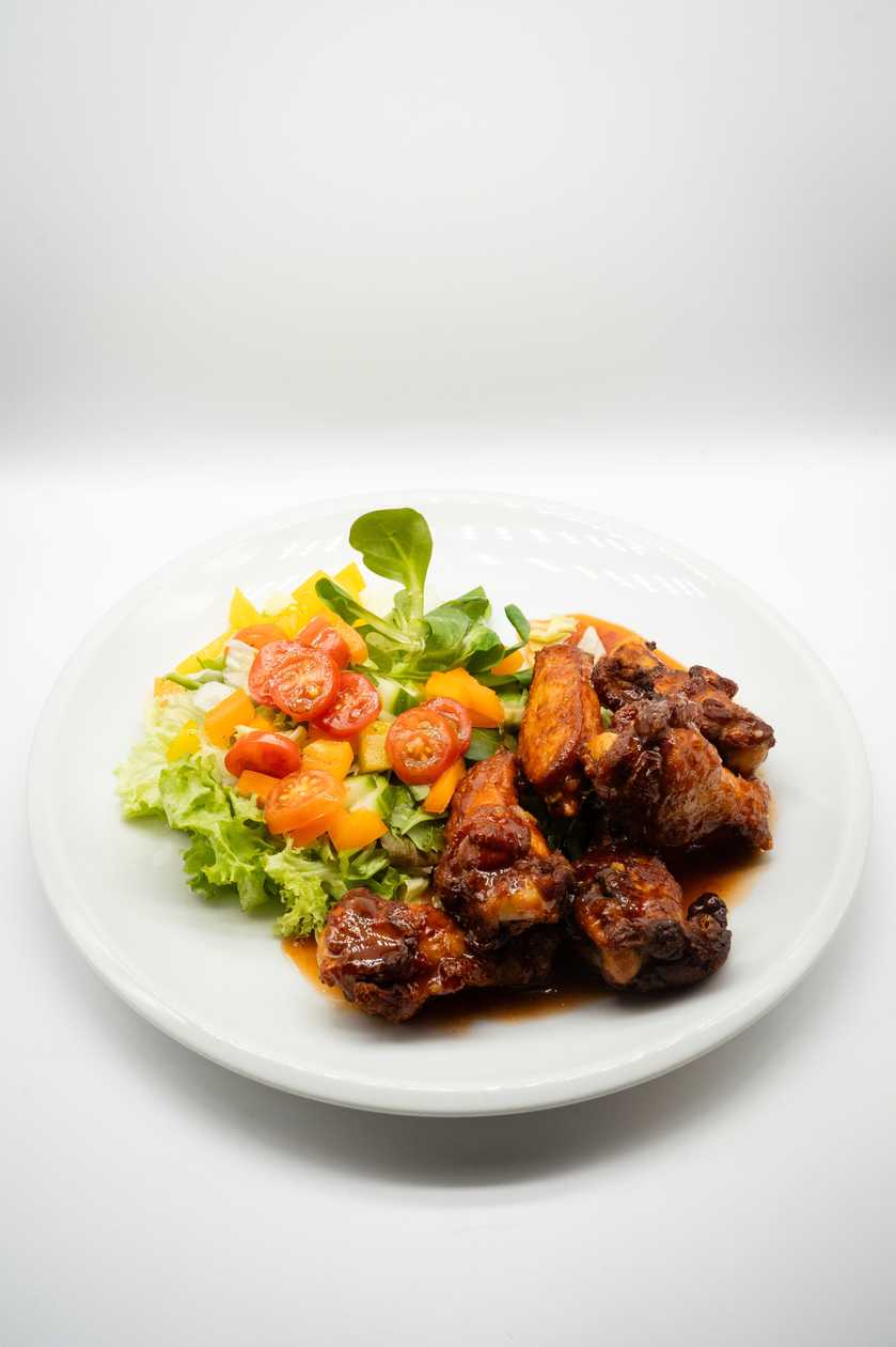 Marinated chicken BBQ wings with mixed salad