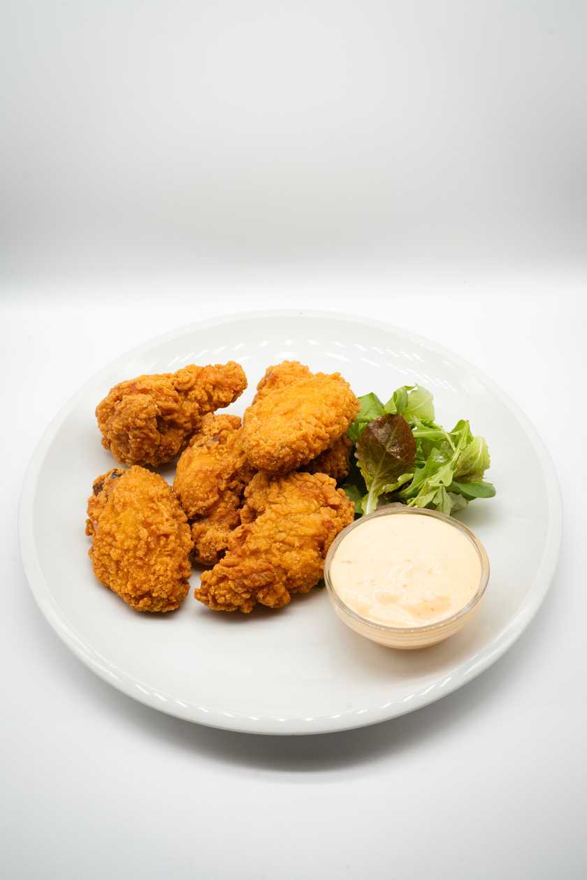 Chicken wings coated in cornflakes with homemade dressing