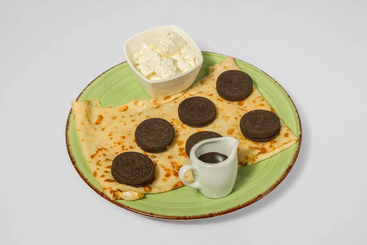 Pancake with Fudge, Mascarpone, Oreo Cookies, Powdered Sugar, Toffee Sauce
